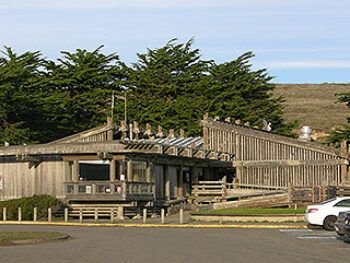 A wood building with a parking lot and blue sky