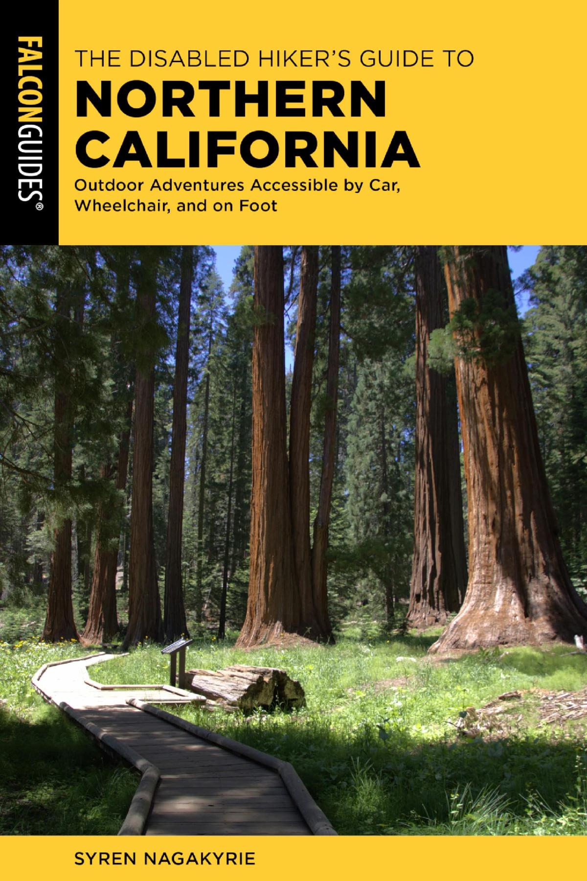 The cover of the book "Disabled Hiker's Guide to Northern California" by Syren Nagakyrie. There are two bands of yellow with black text at the top and bottom of the image, featuring the book and author's name. The photo in the middle is of a redwood tree grove lit by sunlight with green grass and a path winding through the trees.