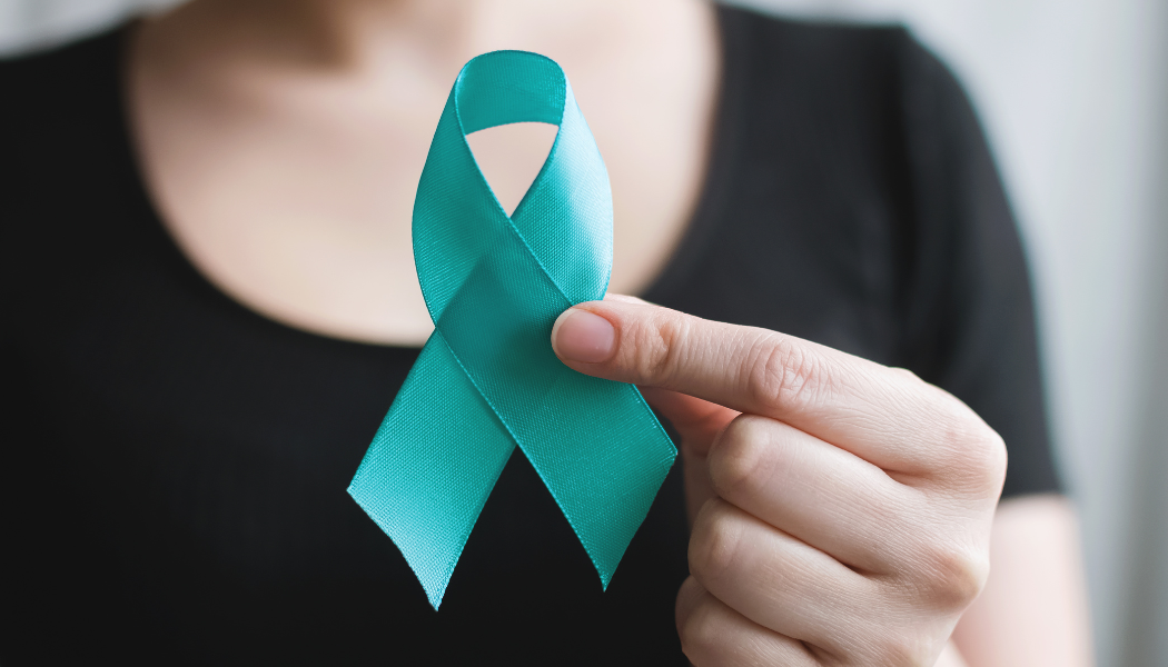Girl holding teal ribbon