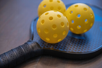 Pickleballs on a paddle 