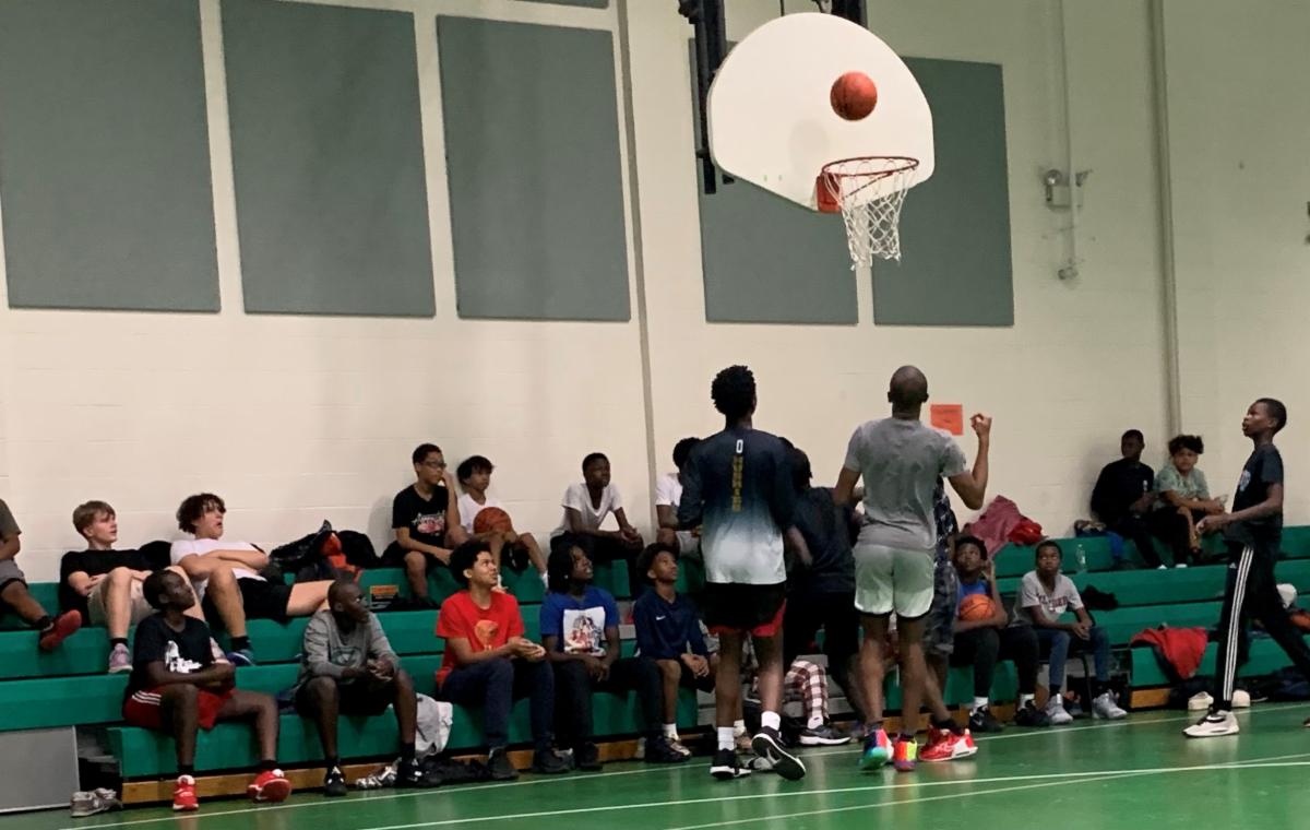 Spectators watching pick-up basketball game 