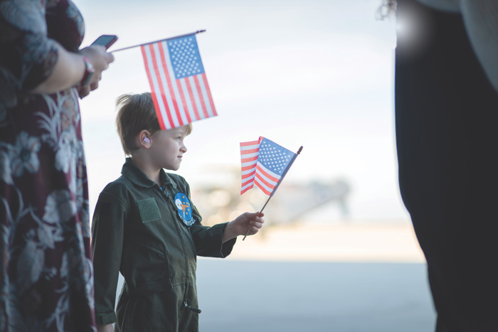Young boy holding USA flag 