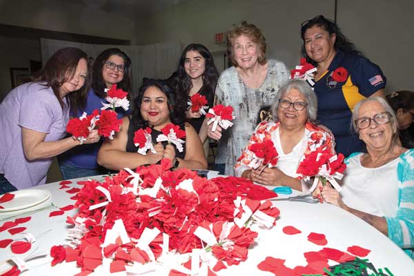 ALA Members with poppies on a table