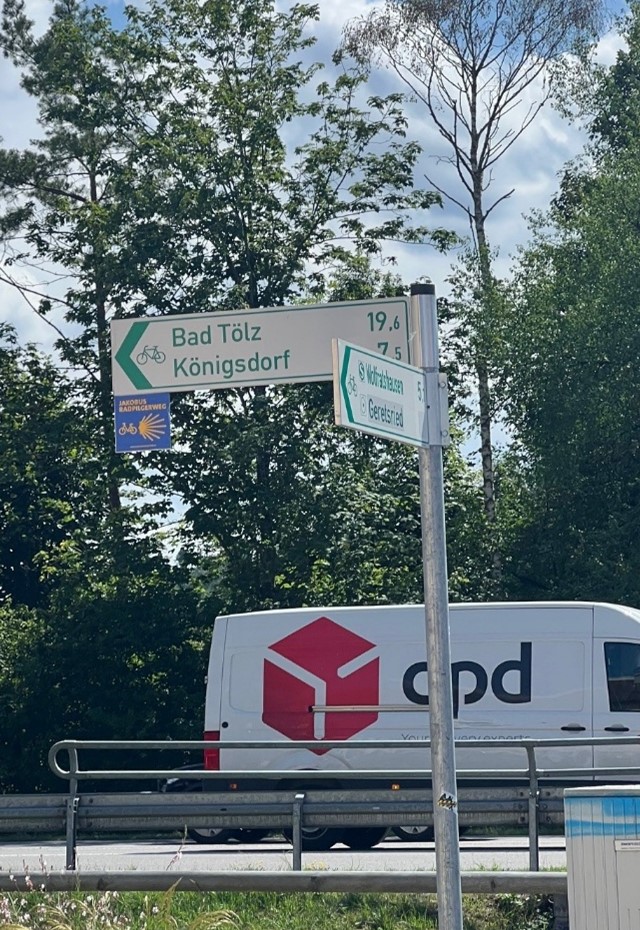 Picture of wayfinding signs in Germany indicating direction and distance for cycling routes.