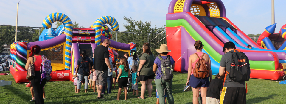 People standing in line for an inflatable at Party in the Park 2023.