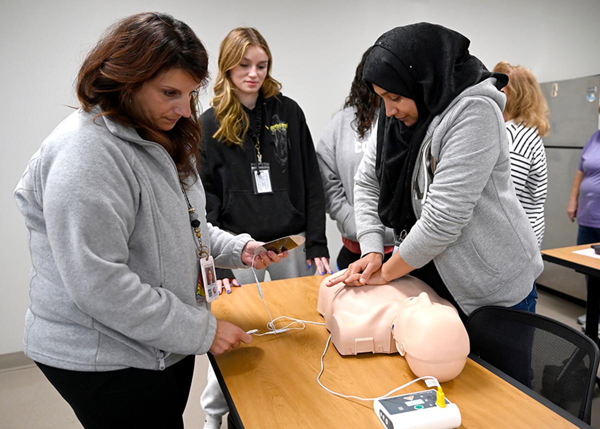 Employees practice CPR on a dummy