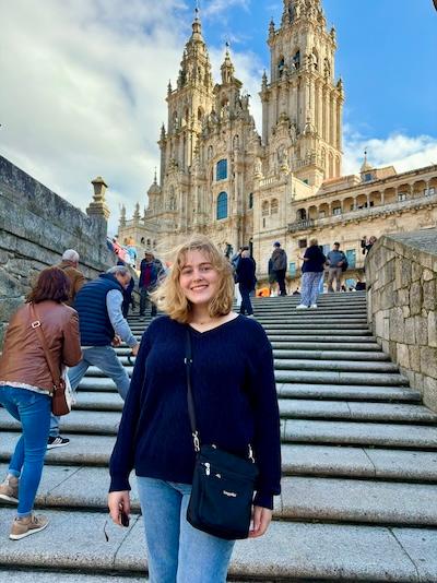 Clare Nugent with cathedral, steps, and people behind her