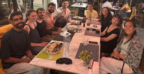 A group of people, including Max Levine, at a restaurant's outdoor table