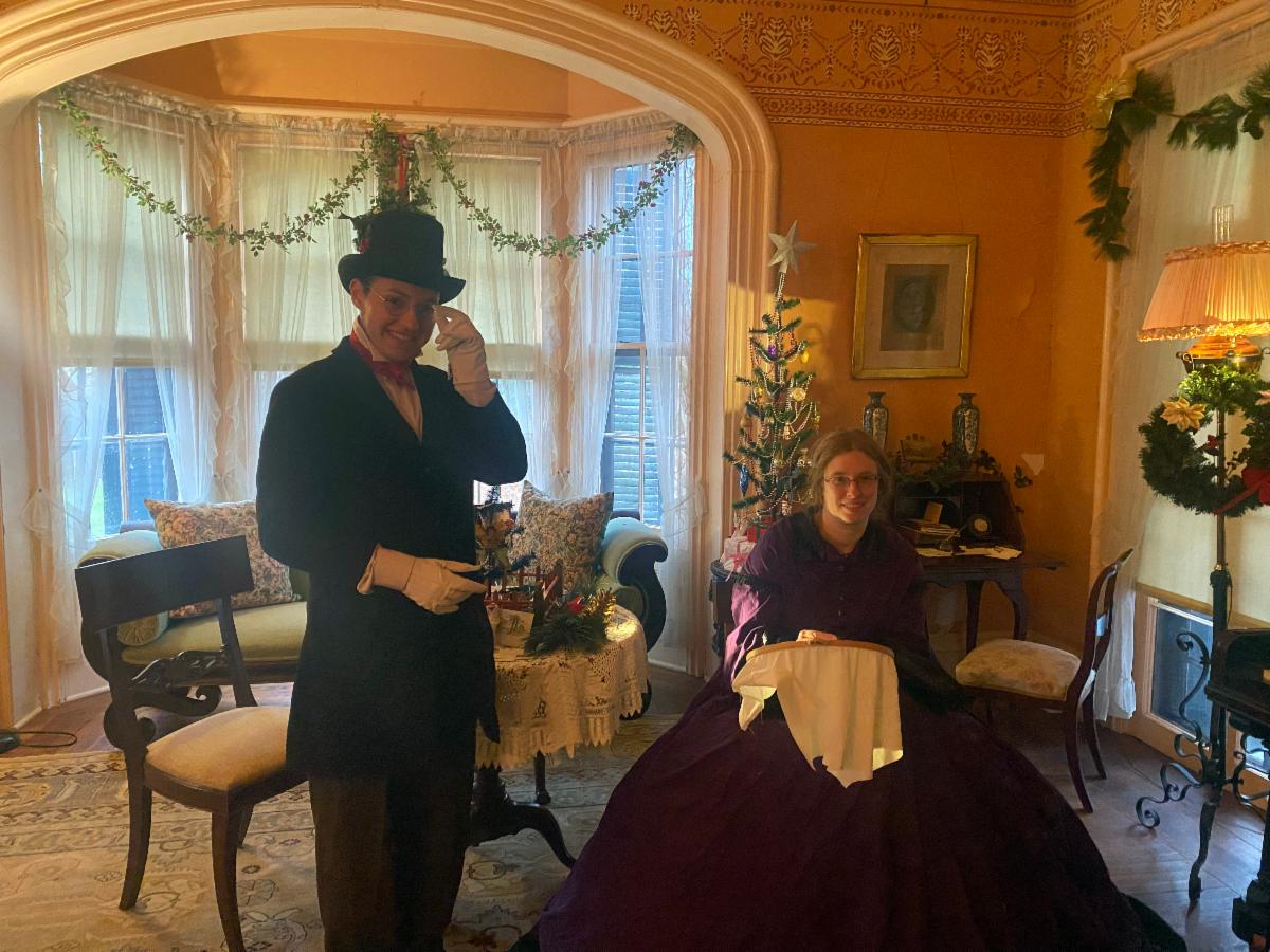 Couple in 1800s dress in parlor