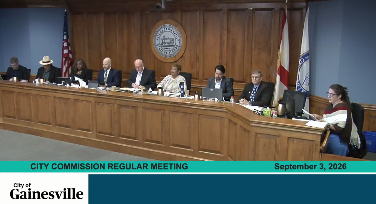 City of Gainesville commission members seated at a wood-paneled dais during a regular meeting on September 3, 2026.  Transcribed Text:  CITY COMMISSION REGULAR MEETING September 3, 2026 City of Gainesville CITY OF GAINESVILLE STATE OF FLORIDA