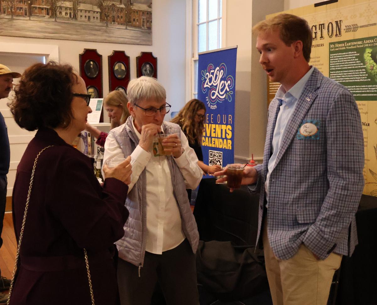 Amy Wilson, Terry Newcomb, and Ethan Morgan chatting at the THM Reception.