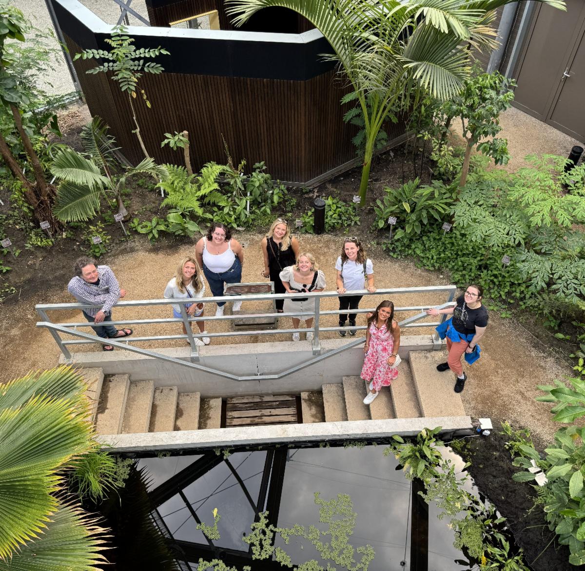 A picture of Dr. Richard with her study abroad students in an indoor arboretum.