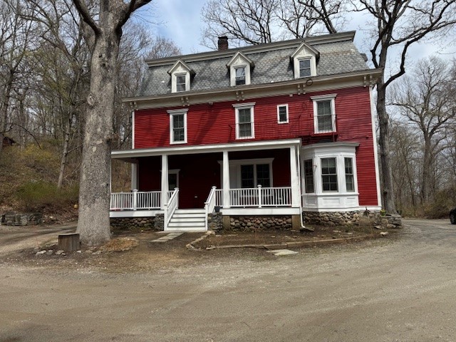 three story red house with renovations completed