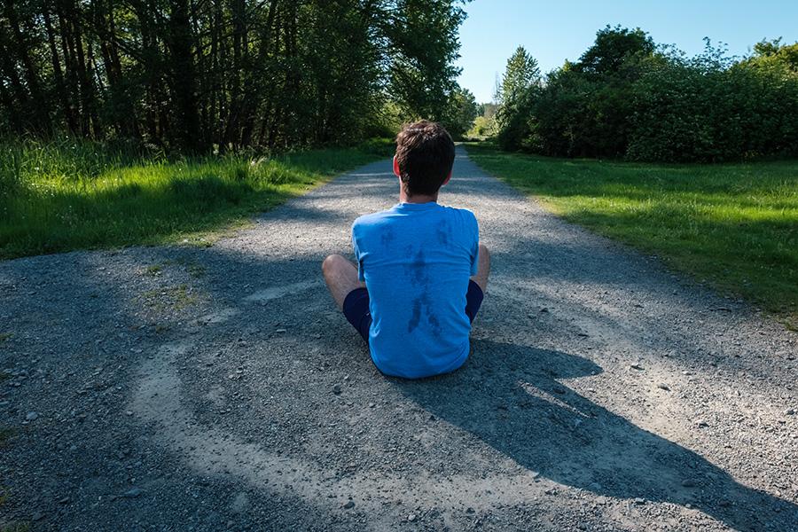 Man sitting on the ground surrounded by a circle