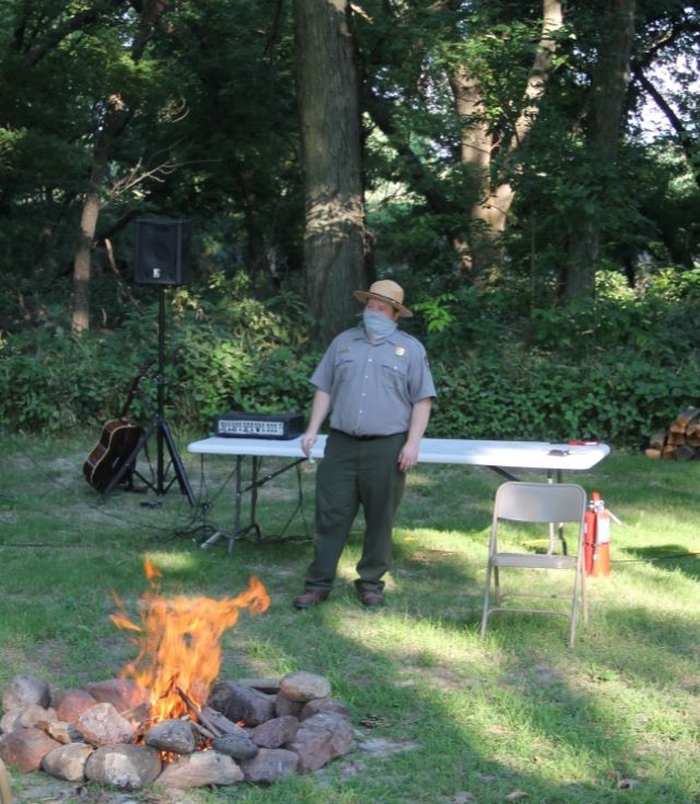 Ranger Jon leading a campfire program outside at the Homestead Education Center
