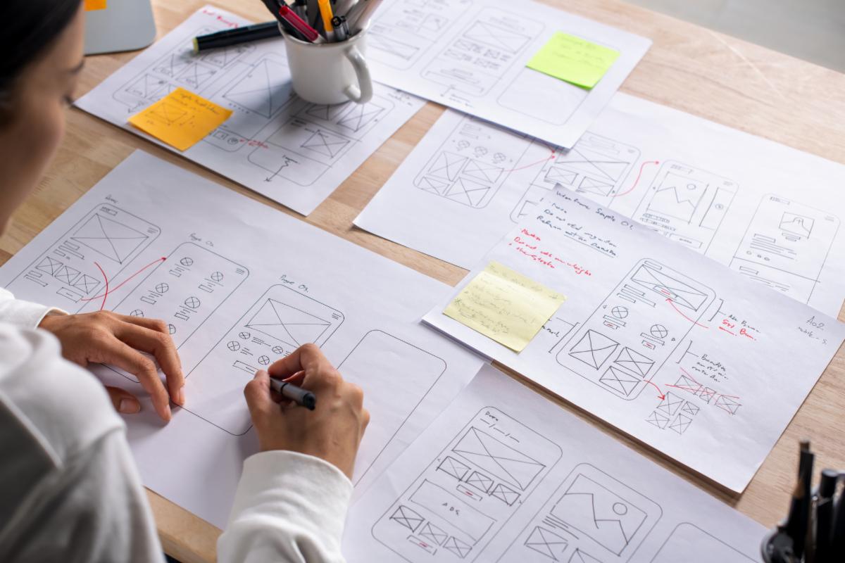 Sketches and wireframes spread across a work surface